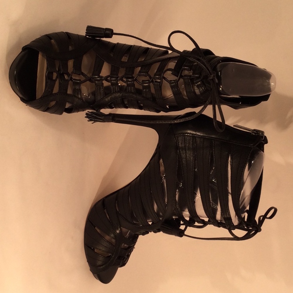 Open toe black sandal with 1/2 platform. Crisscross straps. Tubular straps